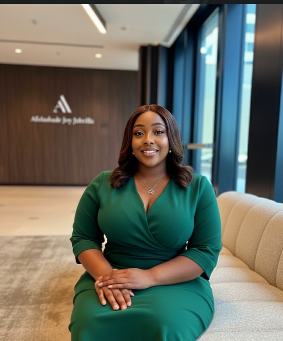 Afolashade in a green dress, poised and professional